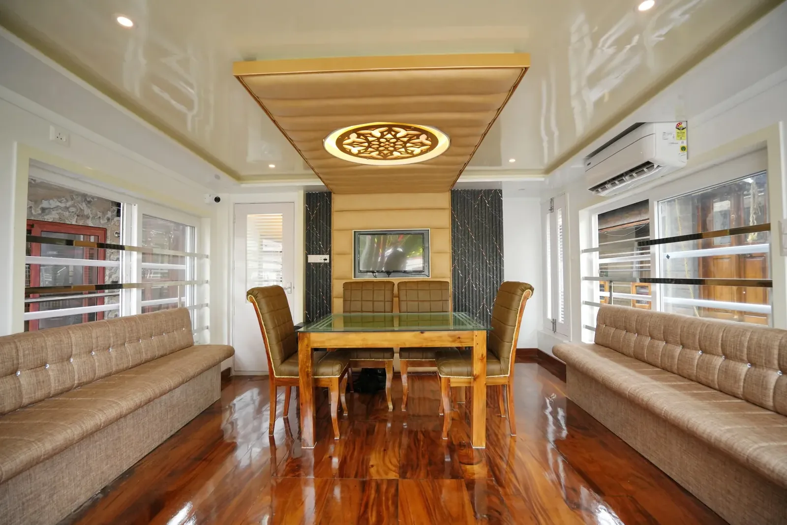 Wide view of the dining and lounge deck on an AGT luxury houseboat, laid out for a meal on board